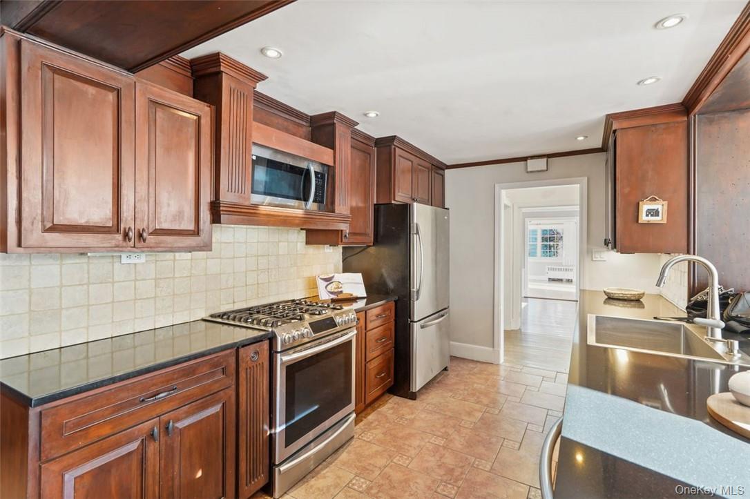 246 Mamaroneck Road Scarsdale, NY 10583 - Photo 16 of 35 Kitchen with dark stone counters
