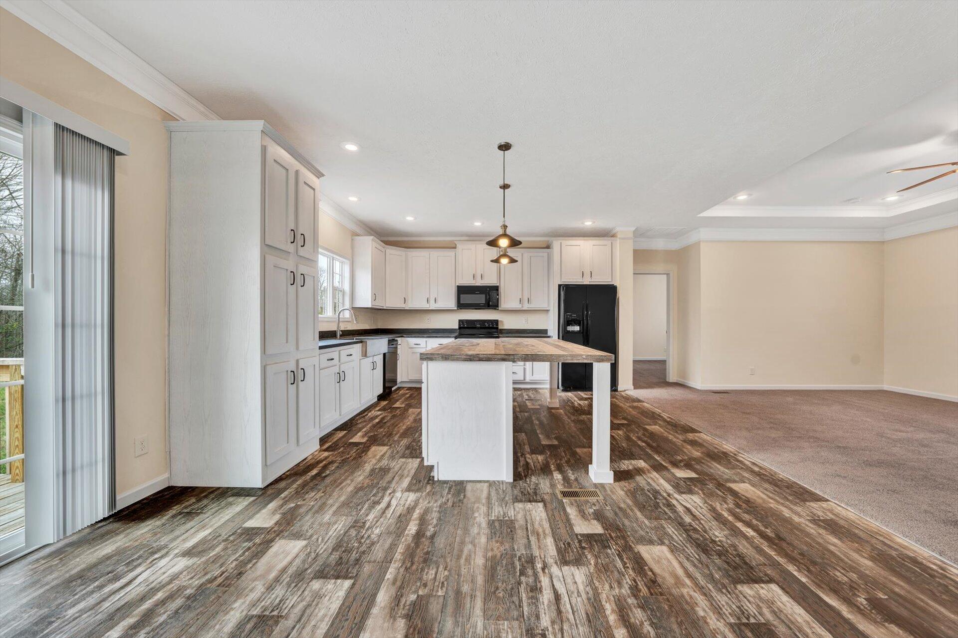 4993 Horseshoe Bend Road Goodview, VA 24095 - Photo 11 of 30 a kitchen with stainless steel appliances kitchen island granite countertop a stove top oven a sink and a refrigerator