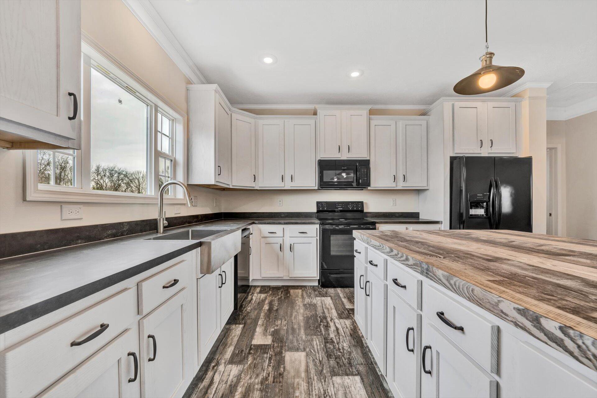 4993 Horseshoe Bend Road Goodview, VA 24095 - Photo 12 of 30 a kitchen with granite countertop white cabinets and white appliances