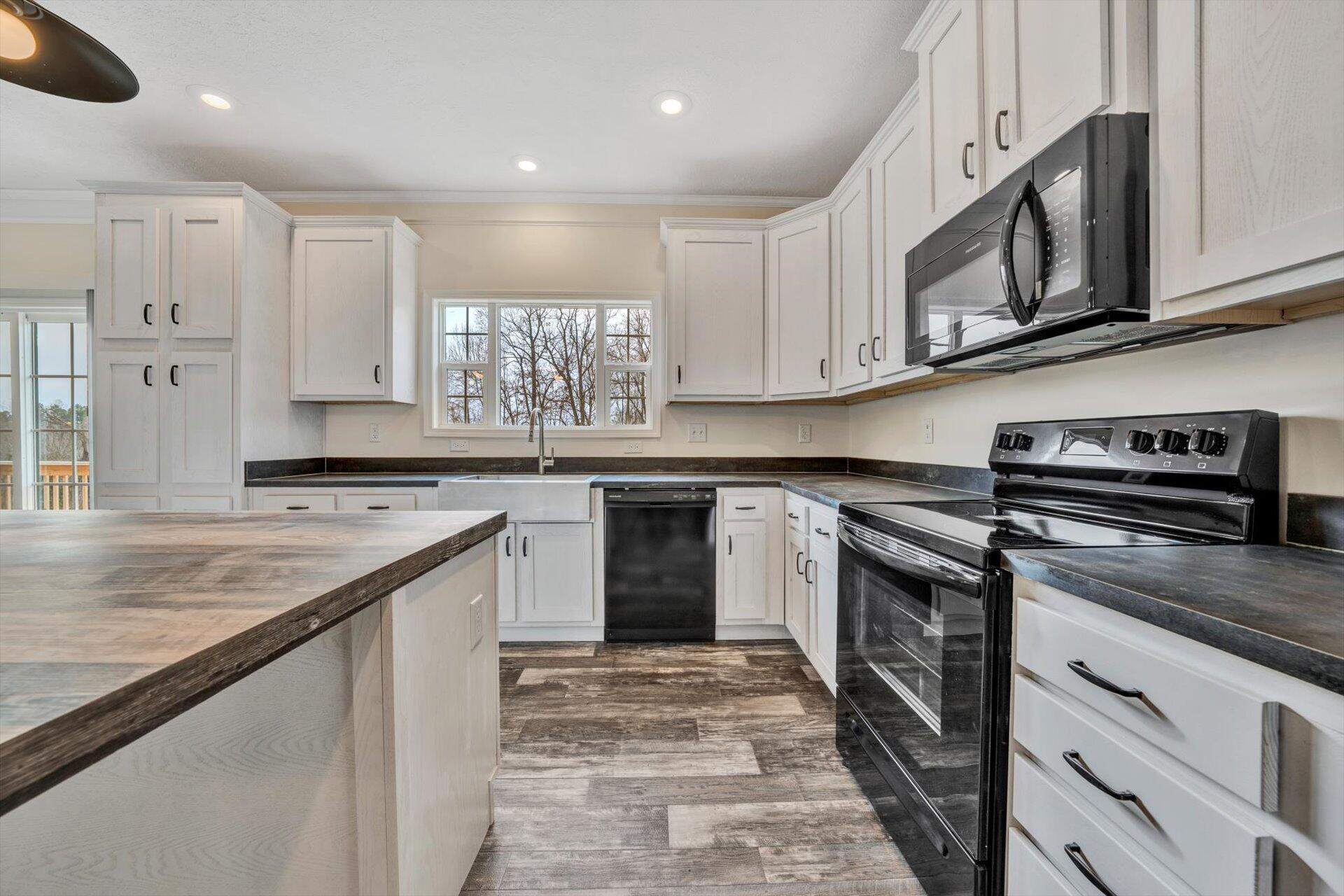 4993 Horseshoe Bend Road Goodview, VA 24095 - Photo 9 of 30 a kitchen with stainless steel appliances granite countertop a stove and a sink