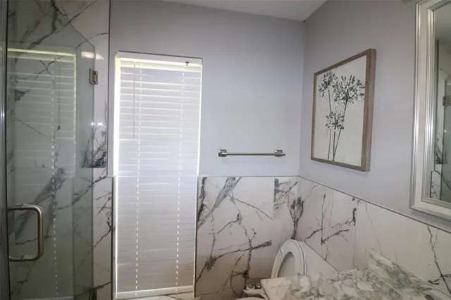 a bathroom with a shower and a shower