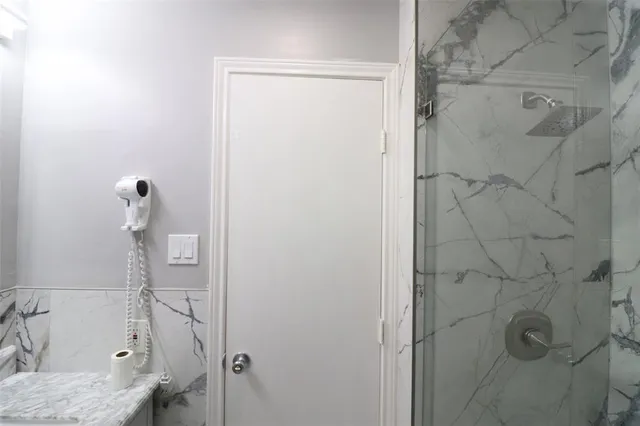 a bathroom with a sink and shower
