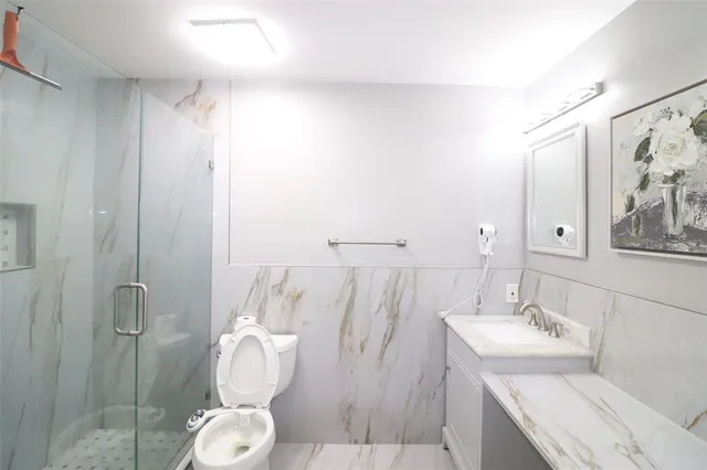 a bathroom with a sink mirror and toilet