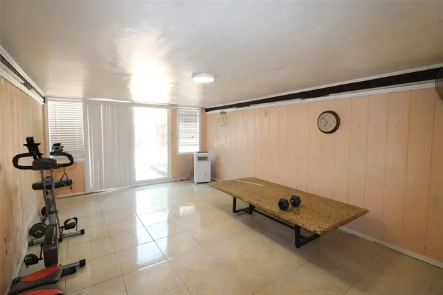 a room with gym equipment and a window