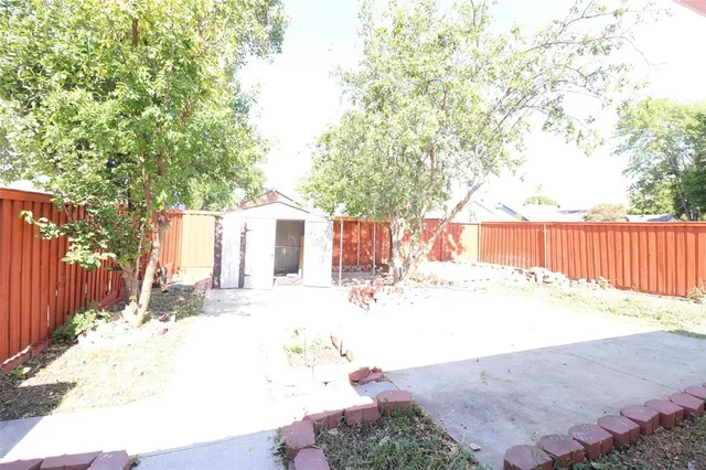 a view of a backyard with a patio and fire pit
