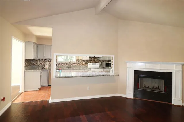 a room with a fireplace and wooden floor