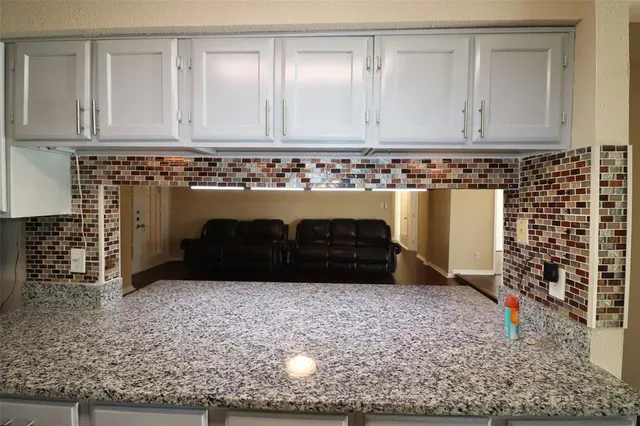 a view of granite countertop white cabinets with a sink