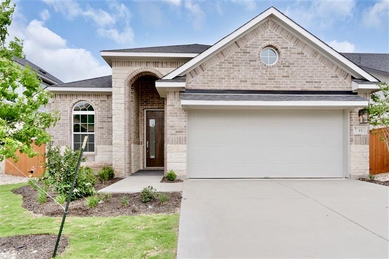 2705 Sage Ranch Drive, Unit 13 Leander, TX 78641 - Photo 1 of 1 a front view of a house with garden
