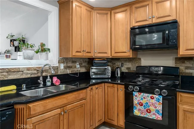 a kitchen with stainless steel appliances granite countertop a stove and cabinets