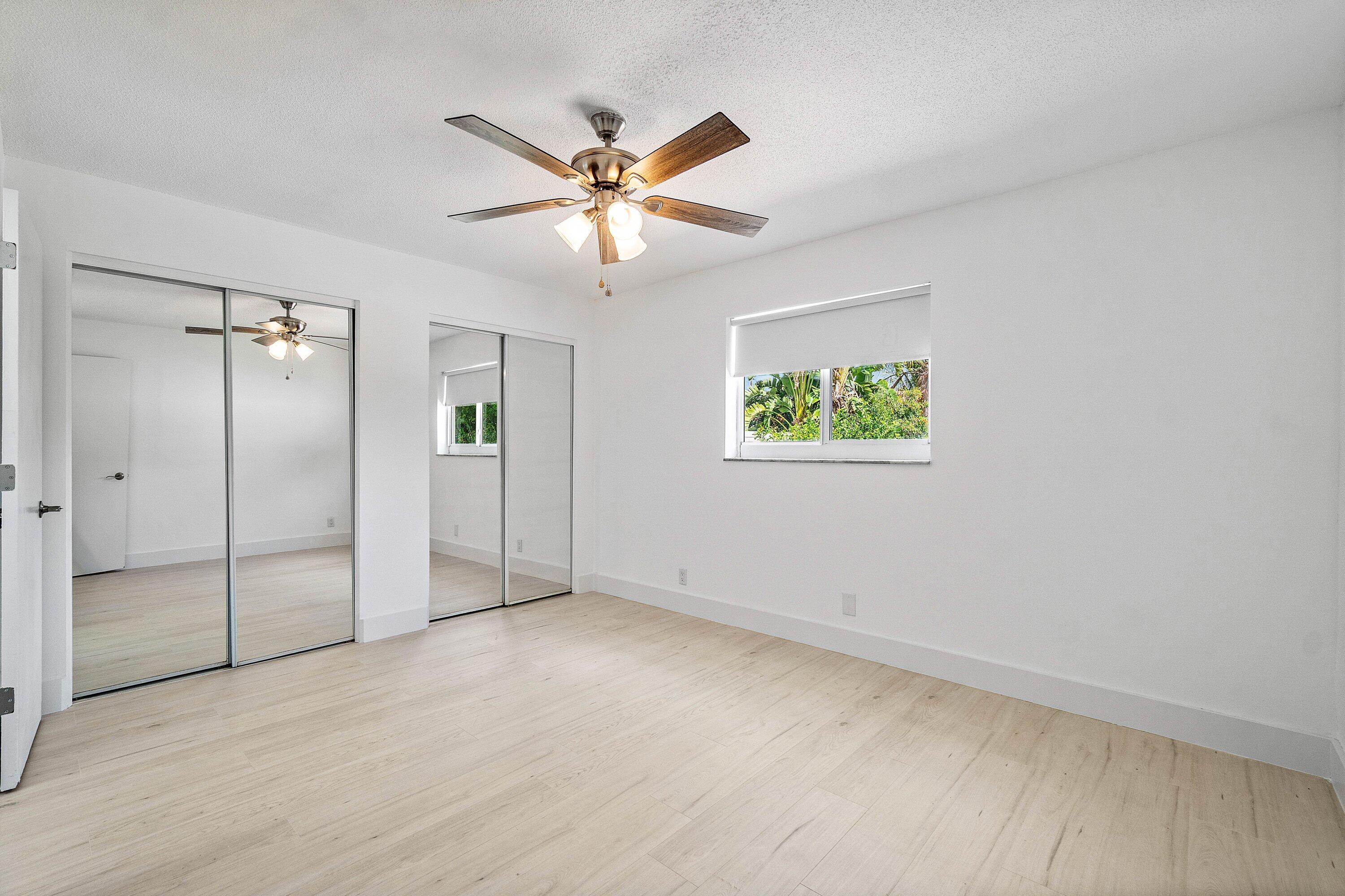 1531 Northwest 4th Street Boca Raton, FL 33486 - Photo 25 of 34 an empty room with windows and fan