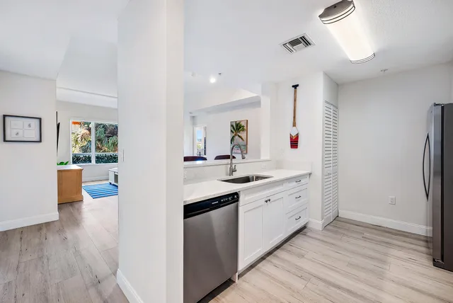 a large kitchen with lot of counter space and wooden floor