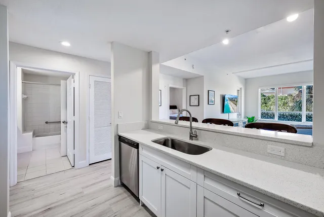 a view of a kitchen with a sink and living room