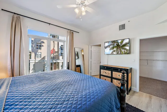 a bedroom with a large bed a painting and a book shelf