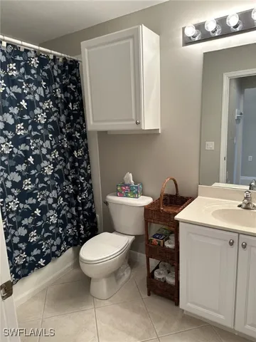 a bathroom with a sink toilet and a mirror