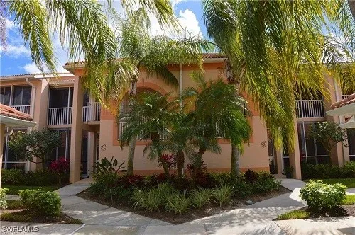 an aerial view of a house with a garden and lake view