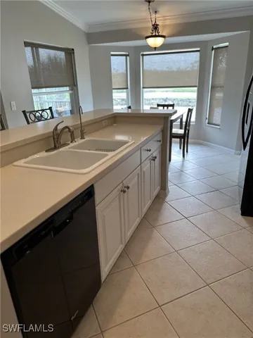 a kitchen with a sink and a stove top oven