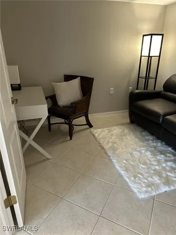 a view of a livingroom with furniture and a window
