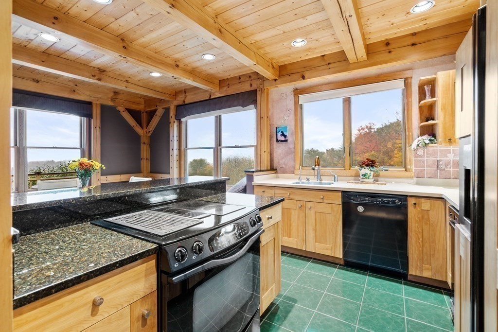 66 Fiskdale Road Brookfield, MA 01506 - Photo 15 of 32 a kitchen with a stove sink and cabinets