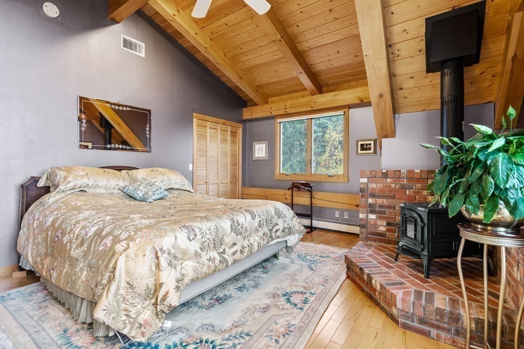 66 Fiskdale Road Brookfield, MA 01506 - Photo 24 of 32 a bed sitting in a bedroom next to a window