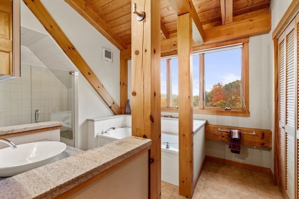 66 Fiskdale Road Brookfield, MA 01506 - Photo 25 of 32 a bathroom with a granite countertop sink and a mirror