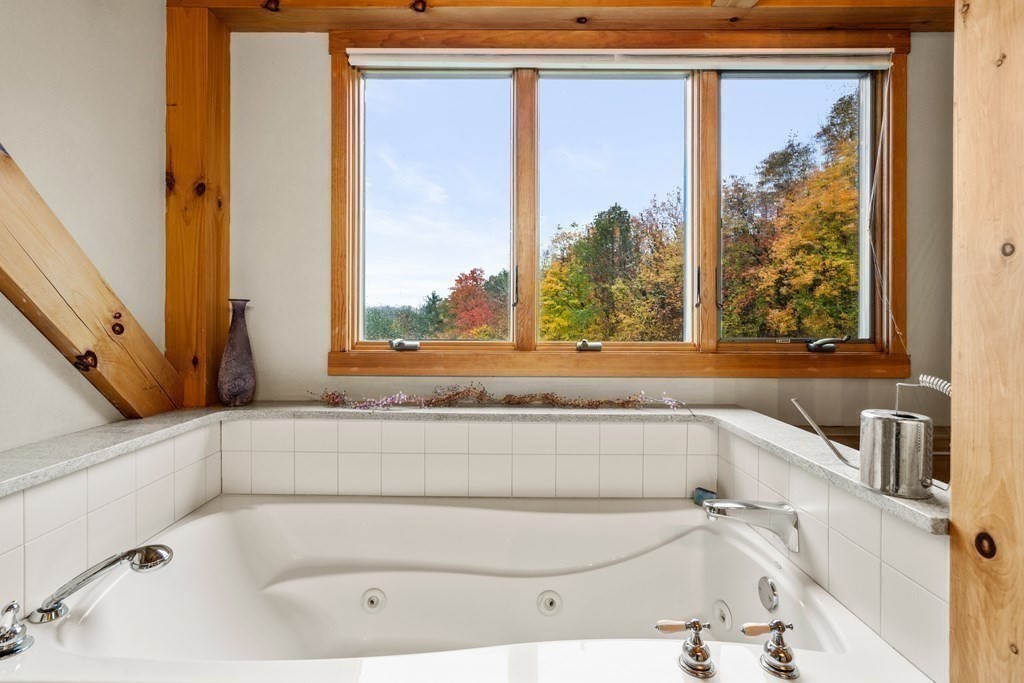 66 Fiskdale Road Brookfield, MA 01506 - Photo 27 of 32 a bathroom with a bathtub and a window