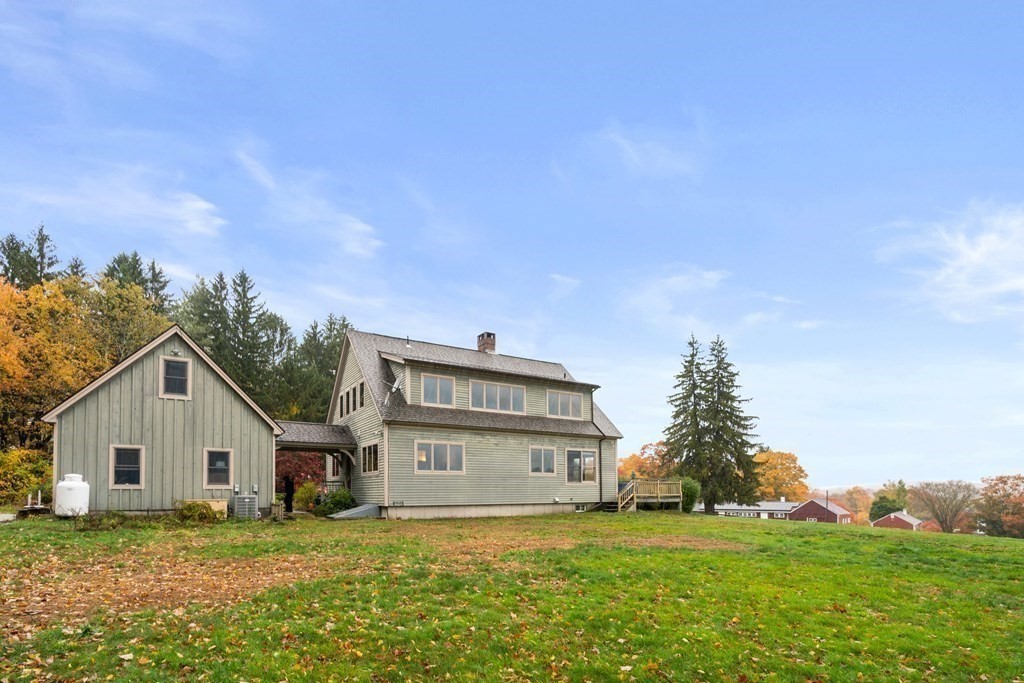 66 Fiskdale Road Brookfield, MA 01506 - Photo 8 of 32 a view of a house with a big yard and a large tree