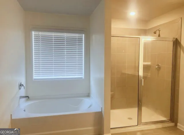 a bathroom with a bathtub and a shower