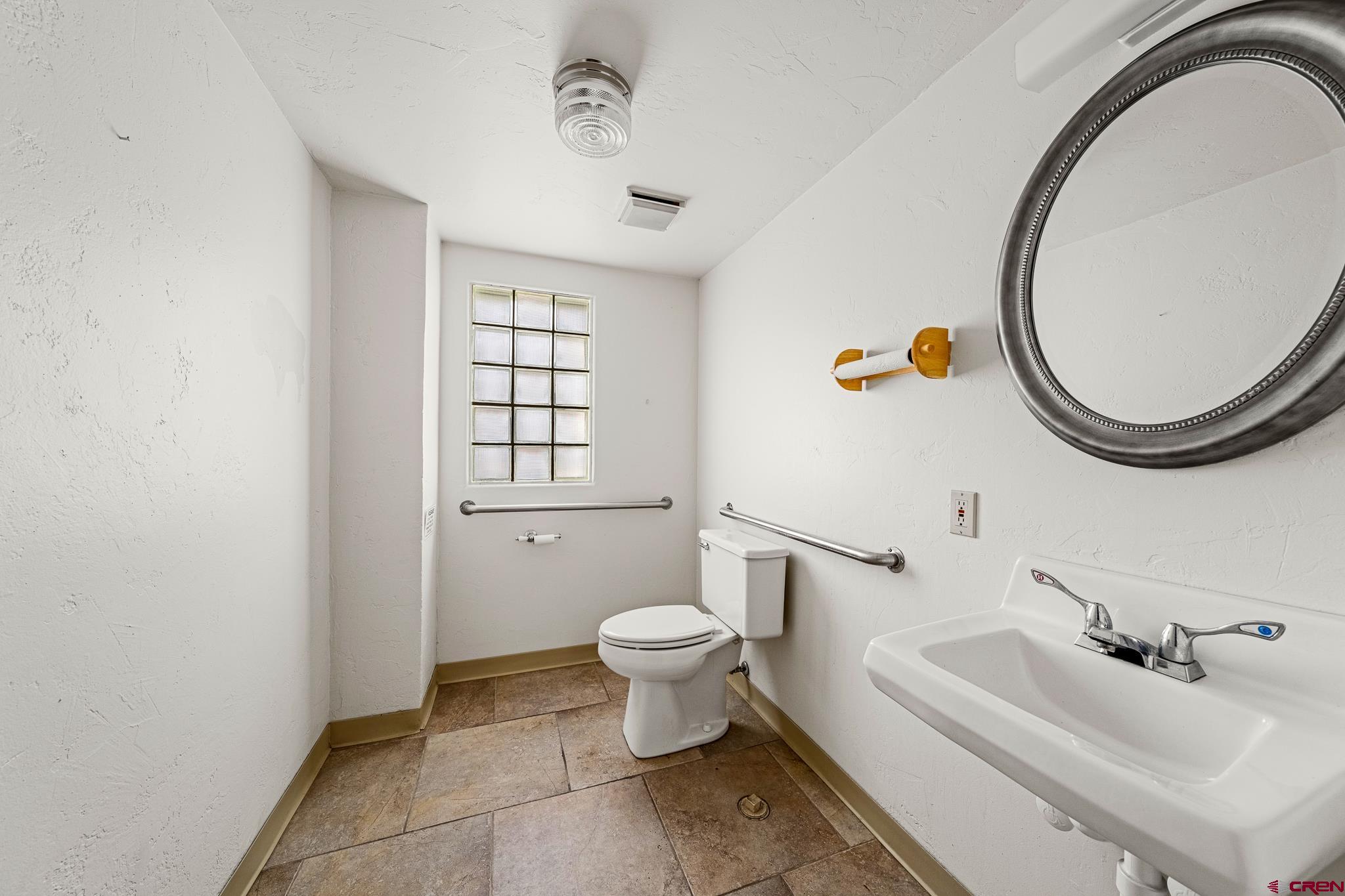 1304 Main Avenue Durango, CO 81301 - Photo 19 of 35 a bathroom with a sink a toilet and a mirror