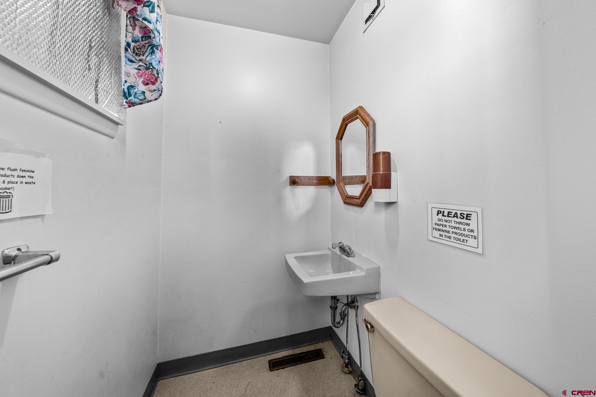 1304 Main Avenue Durango, CO 81301 - Photo 32 of 35 a bathroom with a toilet sink and mirror