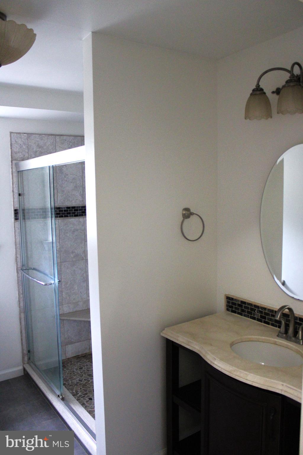 42 Forge Road Medford, NJ 08055 - Photo 8 of 10 a bathroom with a granite countertop sink a toilet and a mirror