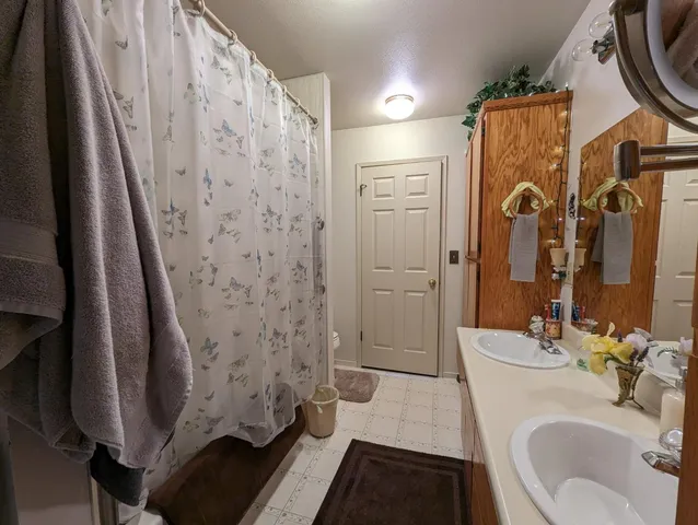 a bathroom with a sink double vanity and a mirror