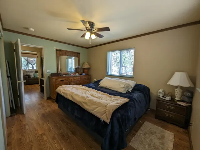 a view of a bedroom with furniture and wooden floor