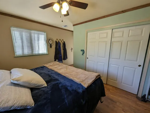 a bedroom with a bed and a chandelier