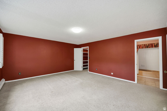 1365 Sumac Drive Logan, UT 84321 - Photo 36 of 66 Spacious room featuring neutral carpeting, red-painted walls, and a ceiling-mounted light fixture