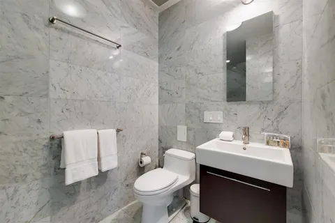 a bathroom with a sink toilet and mirror