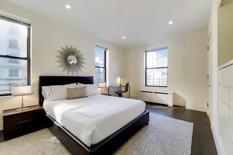 a spacious bedroom with a bed and a window
