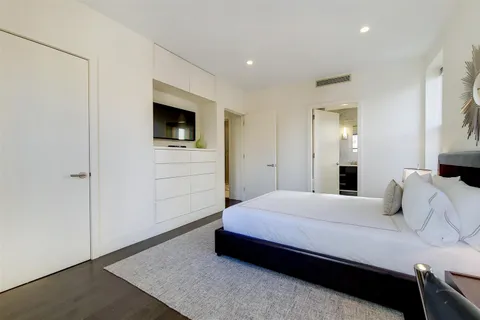 a bedroom with a bed and a television