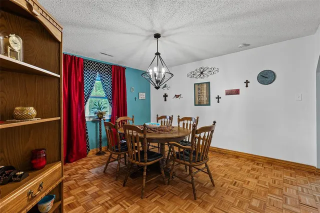 a view of a dining room with furniture and chandelier