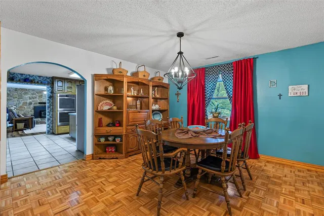 a view of a dining room with furniture and a chandelier
