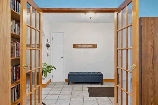 a view of a hallway to a livingroom with furniture