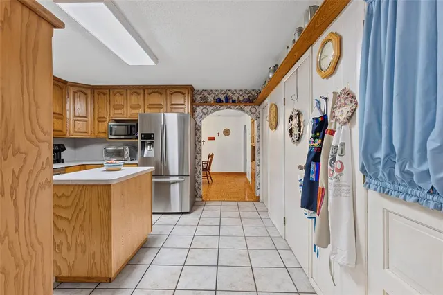 a kitchen with stainless steel appliances a refrigerator sink and cabinets