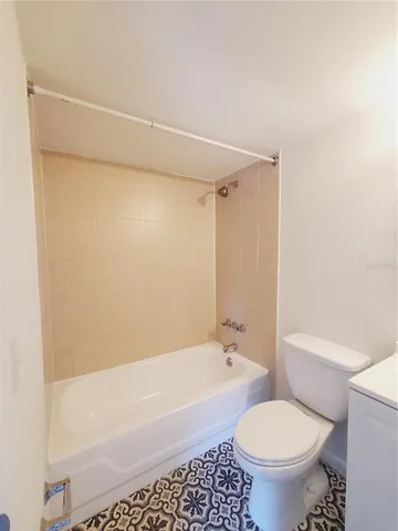 a bathroom with a toilet and a bathtub