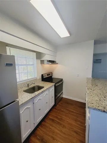 a kitchen with sink and cabinets