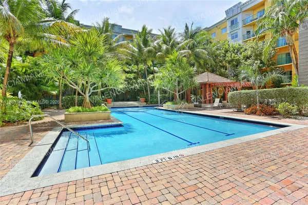swimming pool view with a seating space