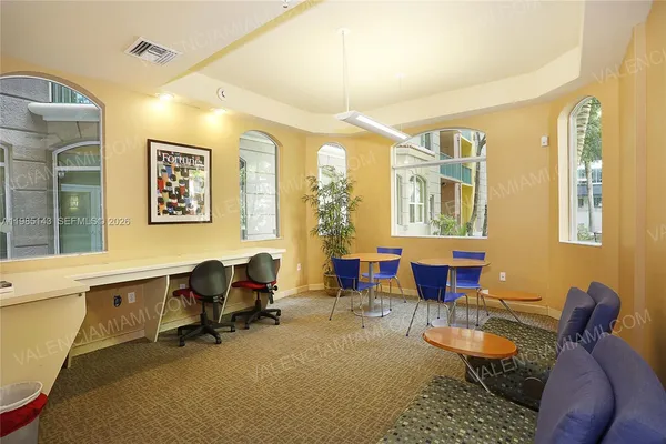 a view of a livingroom with workspace and a window