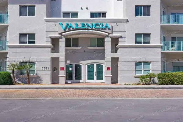 a front view of a building with a garden