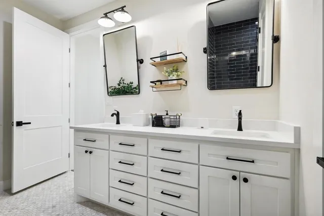 a bathroom with a double vanity sink mirror and