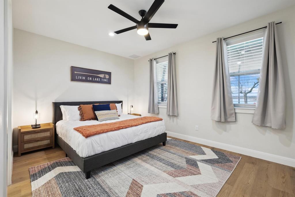 413 Hoot Avenue Graford, TX 76449 - Photo 13 of 38 a bedroom with a bed and a large window