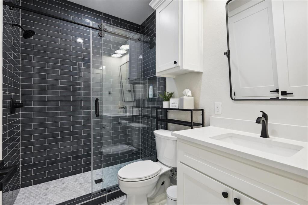 413 Hoot Avenue Graford, TX 76449 - Photo 14 of 38 a bathroom with a sink a toilet and shower