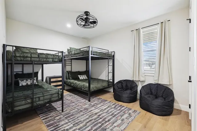 a bedroom with furniture and wooden floor